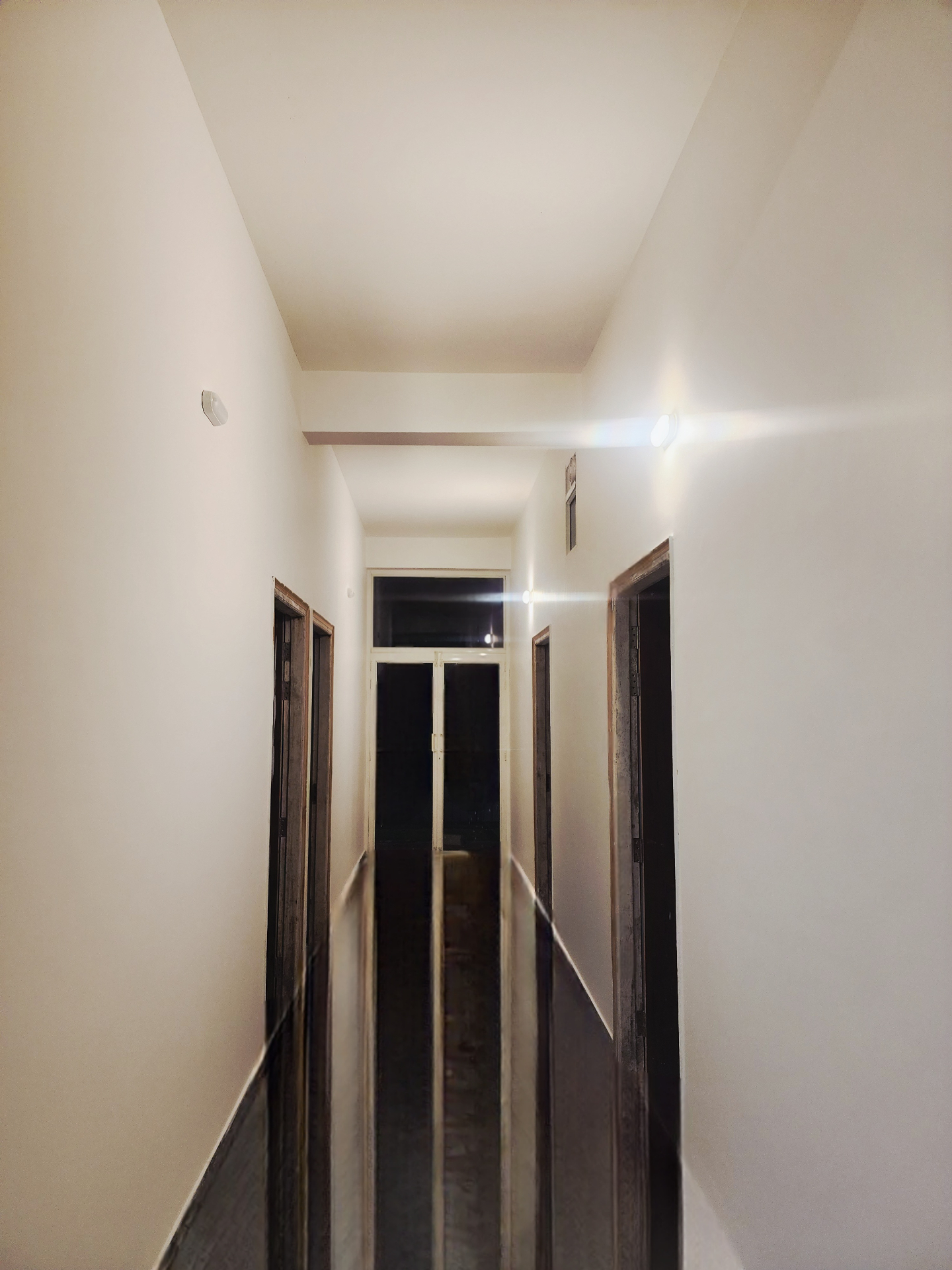 Wide, well-lit guest room aisle