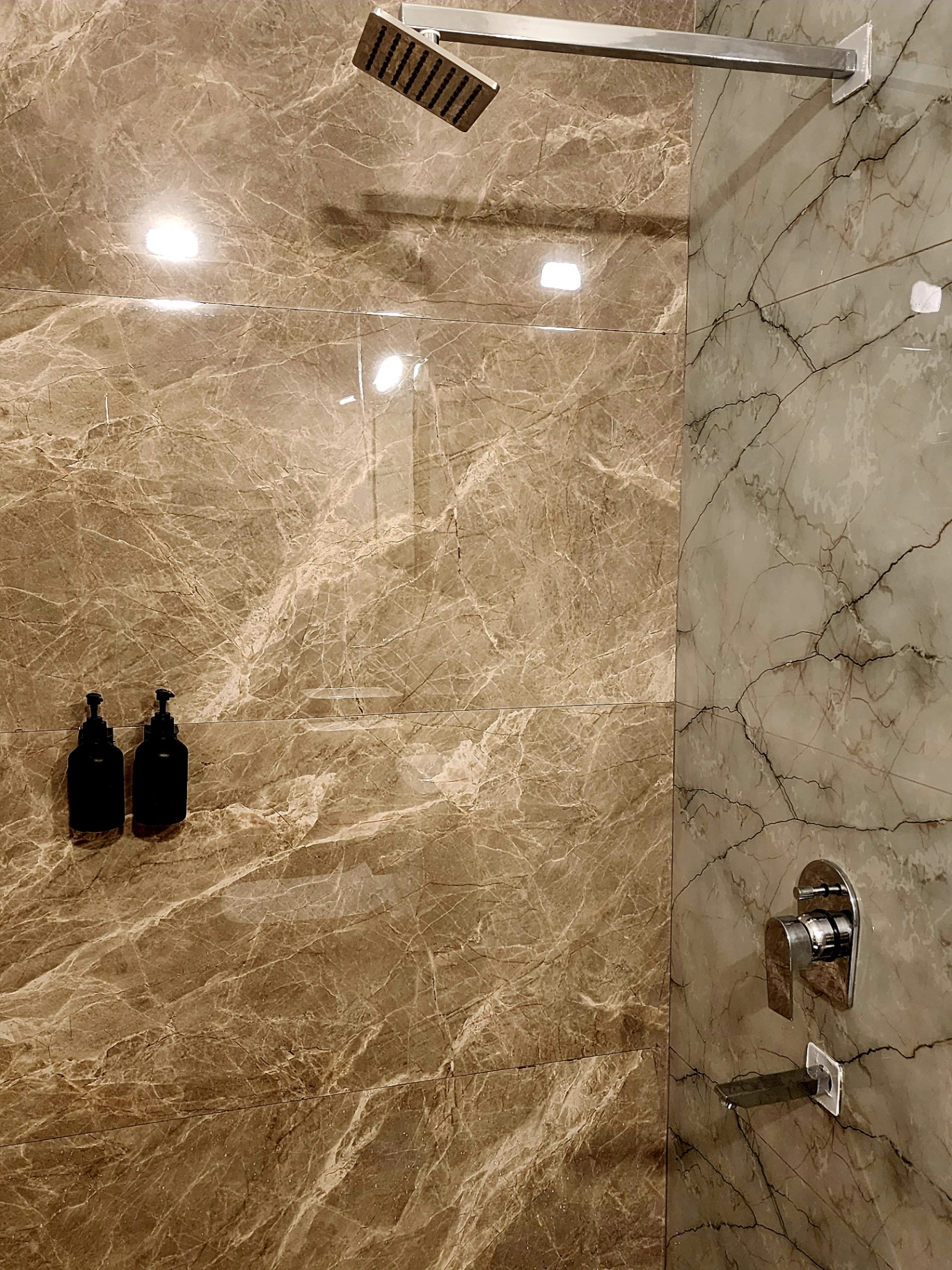 Rain shower against polished marble cladding