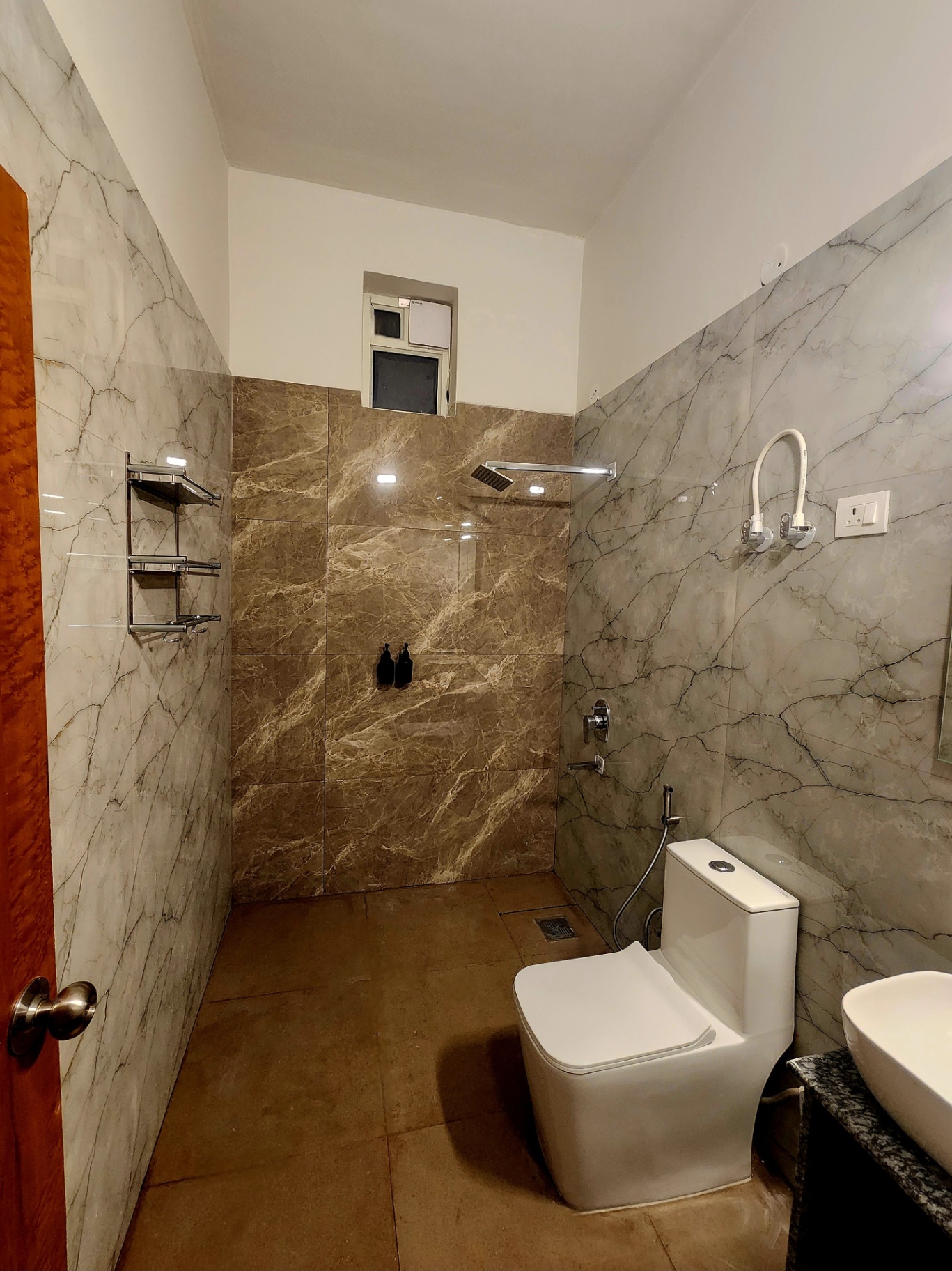 Modern marble bathroom with rain shower and vanity