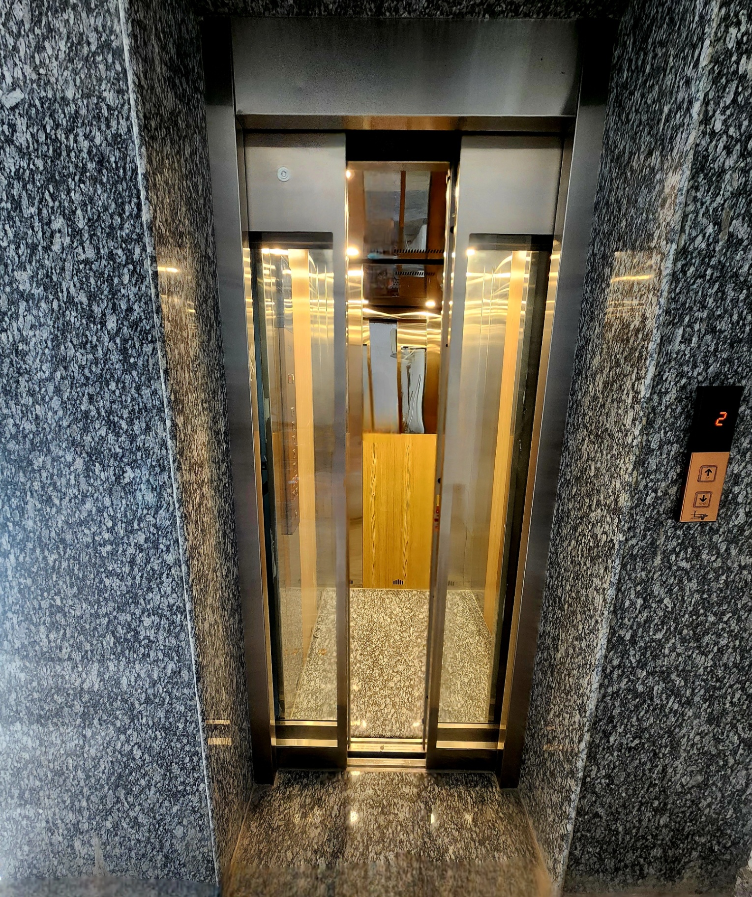 Guest elevator entrance with stone cladding